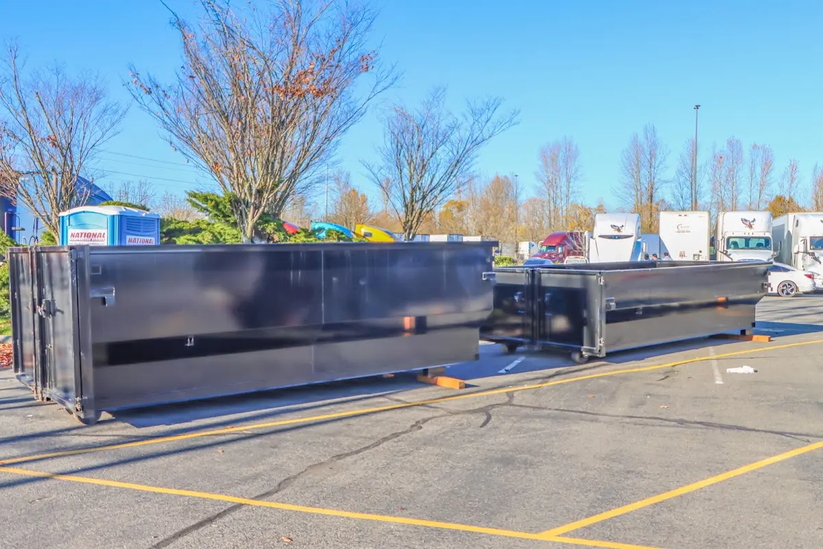 Professional dumpster rental service with roll-off container on residential driveway in New Hempstead